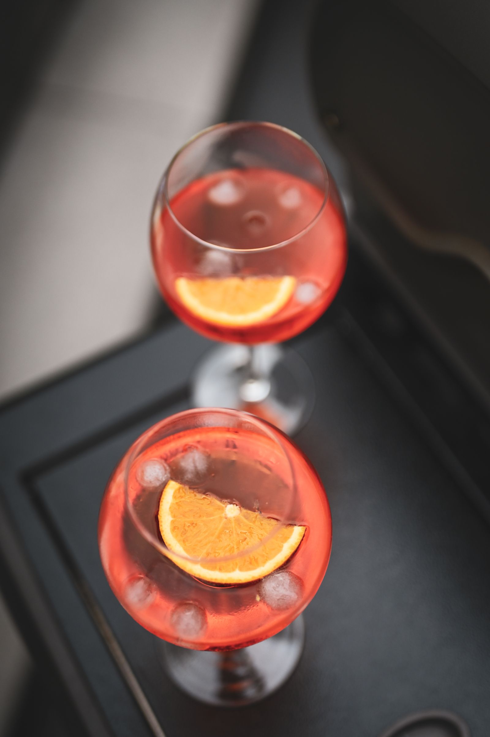 Two citrus cocktails ready to enjoy at an outdoor celebration